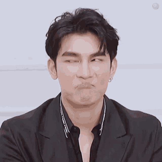 a close up of a man making a funny face with his eyes closed