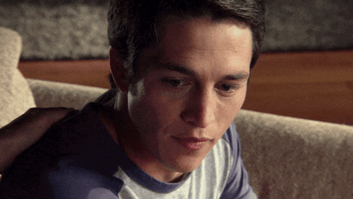 a close up of a man 's face with a person 's hand on his shoulder