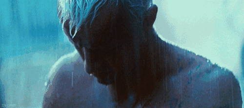 a man with blue hair is taking a shower in a dark room with a watermark that says zuorin