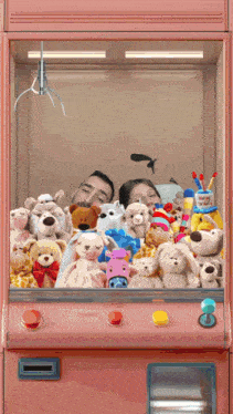 a man and a woman are playing a game with stuffed animals