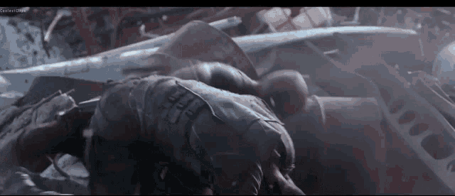 a man in a suit is laying on a pile of junk .