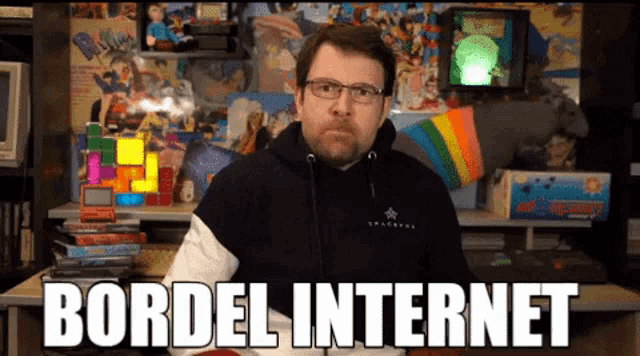 a man wearing glasses and a black hoodie with the words bordel internet written on it