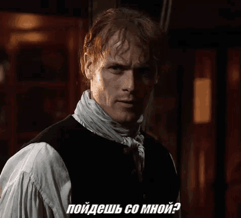 a man with a scarf around his neck is talking in a foreign language