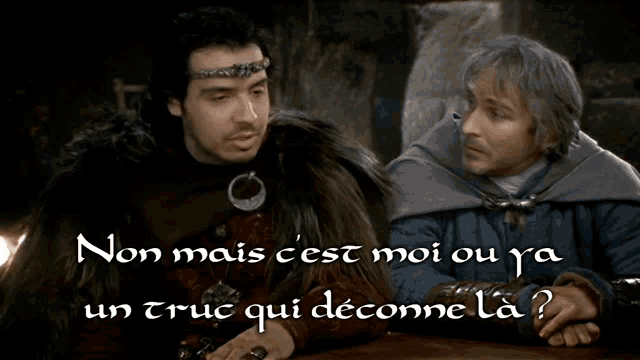 two men are sitting at a table with the words non mais cest moi ou ya un truc qui deconne la on the bottom