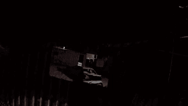 a dark room with a light shining on the wall
