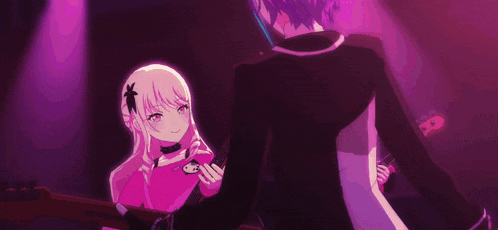 a boy with purple hair is dancing with a girl in a dark room .