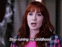 a woman with red hair and a plaid shirt says stop ruining my childhood .