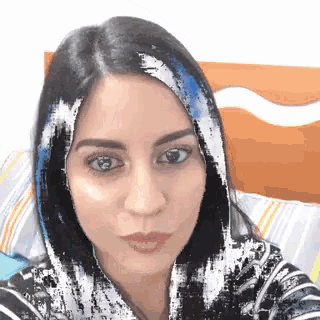 a close up of a woman 's face with a blurry background