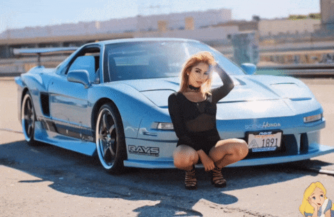 a woman is squatting in front of a car that says rays