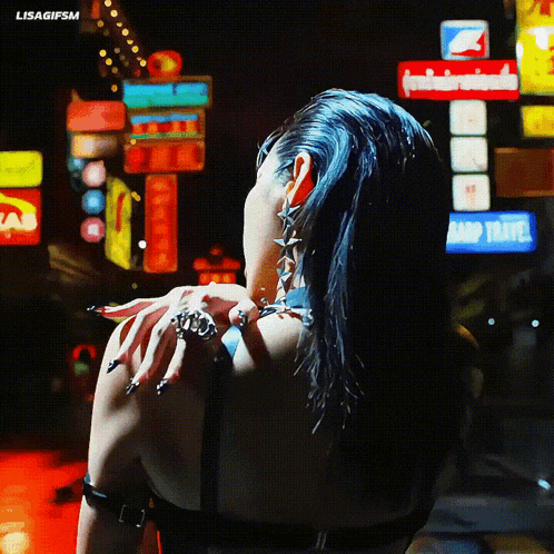 a woman in a black top stands in front of a sign that says ' aarp travel '