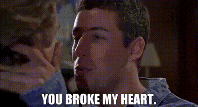 a man in a suit and tie is talking to another man and says `` you broke my heart . ''