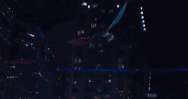 a man in a superhero costume flies over a crowd of people
