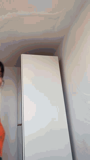 a person standing in a room with a white door