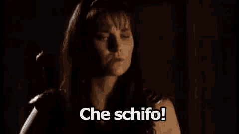 a woman is standing in the dark with the words `` che schifo '' written below her .