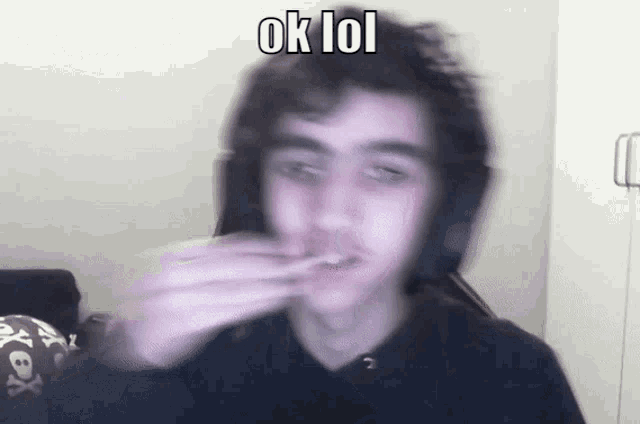 a blurry picture of a man with headphones and the words ok lol above him