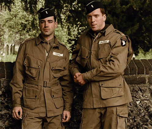 two soldiers are standing next to each other and one of them has a patch on his jacket that says " smith "