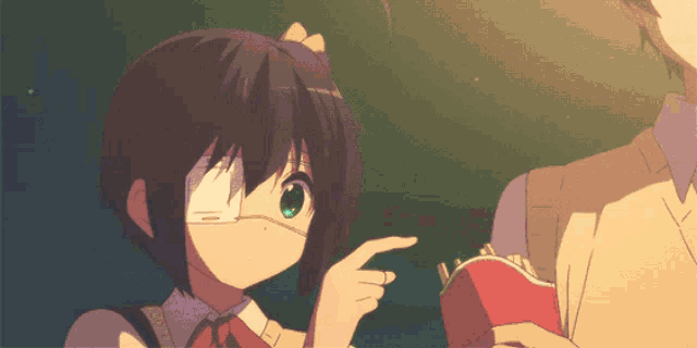 a girl with a bandage on her eye is holding a red wallet