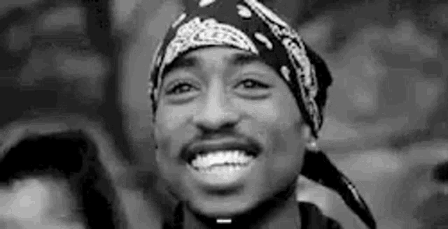 a black and white photo of tupac shakur wearing a bandana .
