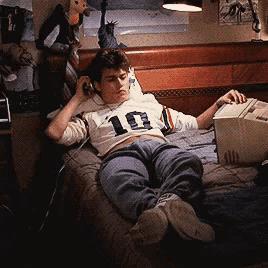 a young man laying on a bed wearing a shirt with the number 10 on it