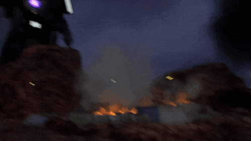 a purple glowing object is flying through the air in a dark room .
