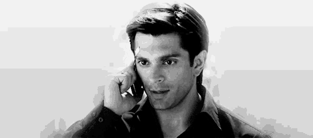 a man is talking on a cell phone .