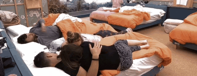 a group of people laying on beds in a room with the word braun on the bottom of the bed