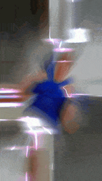 a blurred image of a person 's feet with a blue object in the middle