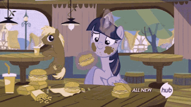 a cartoon of two ponies eating hamburgers with the words all new hub on the bottom right