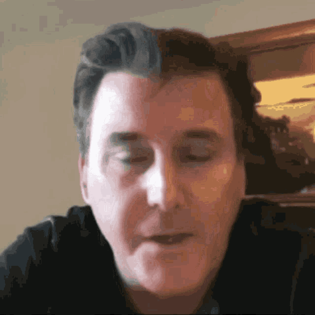 a close up of a man 's face with a blurry background