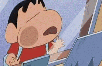 a cartoon character is sitting at a desk with a laptop .