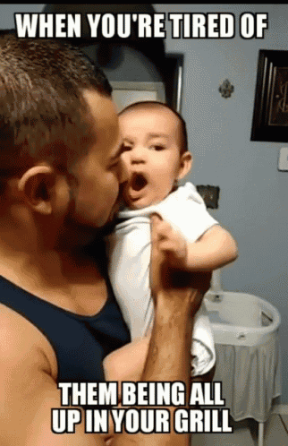a man holding a baby with a caption that says when you 're tired