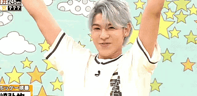 a boy with his arms in the air with a sign that says 245 on it