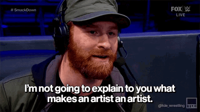 a man with a beard and headphones says i 'm not going to explain