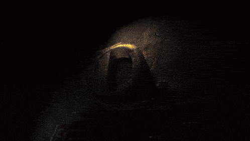 the letter q is surrounded by flames and a dark background