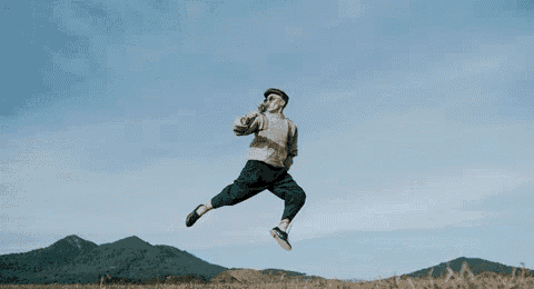 a man in a hat is jumping in the air with the words doc than la mot fac an behind him
