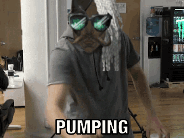 a man wearing sunglasses and a moustache is pumping something