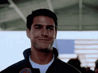 a man wearing a jacket with a patch on it that says ' u.s. navy ' on it