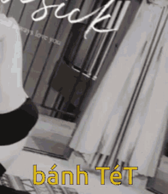 a black and white photo of a person with the words bánh tet written in yellow