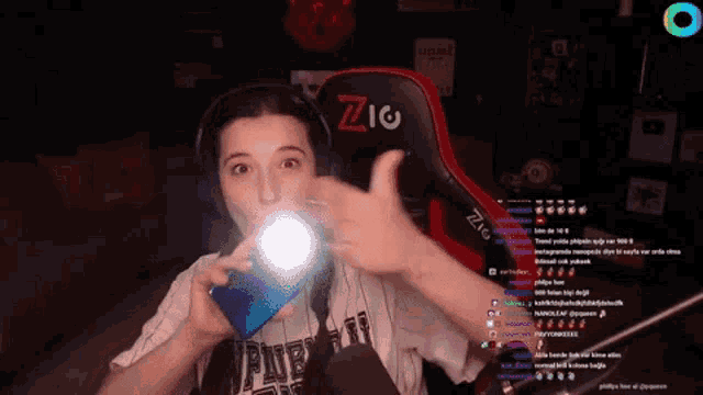 a woman is holding a flashlight in her hand in front of a microphone .