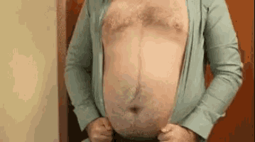 a man with a very large belly is wearing a shirt .