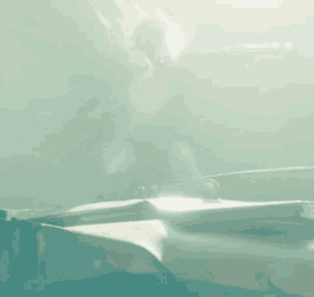 a woman is swimming in the water with her arms outstretched