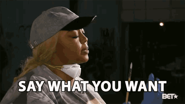 a woman wearing a mask and gloves is holding a brush and saying " say what you want "