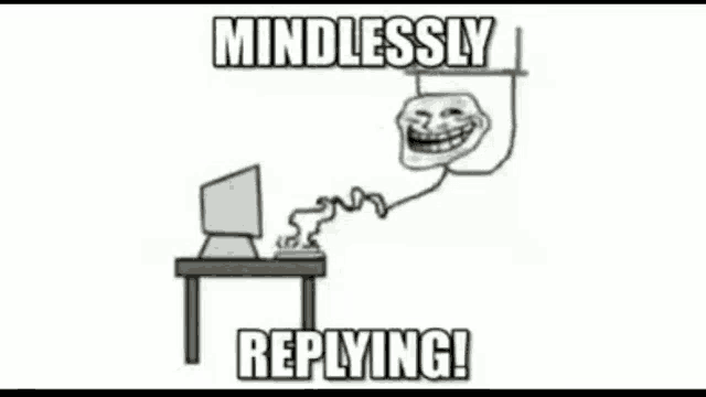 a troll face is sitting at a desk with a computer and says mindlessly replying !
