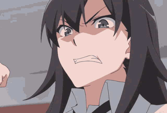 a close up of a girl 's face with an angry look on her face