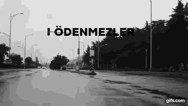 a black and white photo of a street with the words i odenmezler written on it