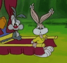 two rabbits are sitting on a bed in a cartoon