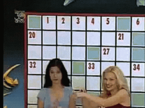 two women are standing in front of a board with the numbers 1 2 3 4 5 6 on it
