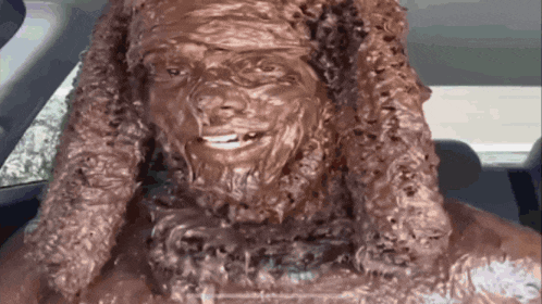 a statue of a man with a beard is sitting in a car