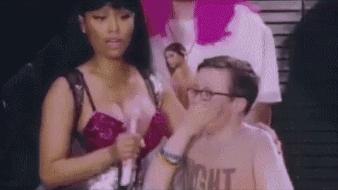 a woman in a pink bra is standing next to a man in a shirt .