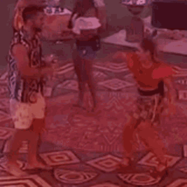 a group of people are dancing on a tiled floor in a room .